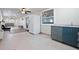 Modern kitchen with teal cabinets and stainless steel appliances at 1571 Jeffords St, Clearwater, FL 33756