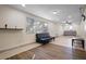 Bright living room with tile and wood flooring, featuring a sleeper sofa and window at 1571 Jeffords St, Clearwater, FL 33756