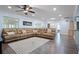 Relaxing living room with a large sectional sofa, hardwood floors, and natural light at 1571 Jeffords St, Clearwater, FL 33756
