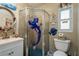 Small bathroom with mermaid-themed shower and pedestal sink at 1611 San Charles Dr, Dunedin, FL 34698