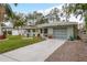 Quaint house with solar panels and a nicely landscaped front yard at 1611 San Charles Dr, Dunedin, FL 34698