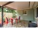 Covered patio with small red table and chairs at 1611 San Charles Dr, Dunedin, FL 34698