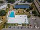 A fantastic aerial view showcases the community pool, solar panels, clubhouse, and parking at 2258 World Parkway W Blvd # 8, Clearwater, FL 33763