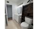 Bathroom featuring tile floors, white vanity, a dark wood cabinet, and white wall tiles at 2258 World Parkway W Blvd # 8, Clearwater, FL 33763