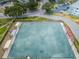 Aerial view of a bocce ball court, benches, shaded canopy, green landscaping, and parking at 2258 World Parkway W Blvd # 8, Clearwater, FL 33763