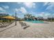 Inviting community pool area with plenty of lounge chairs and shade umbrellas at 2258 World Parkway W Blvd # 8, Clearwater, FL 33763