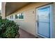 Building 8 front door view with security door, ground level entry, and colorful flora at 2258 World Parkway W Blvd # 8, Clearwater, FL 33763