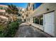Exterior side of the home featuring a concrete path, palm tree, and door to enter into the home at 2258 World Parkway W Blvd # 8, Clearwater, FL 33763