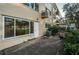 Building exterior featuring a door and large window, with AC and some shrubs outside at 2258 World Parkway W Blvd # 8, Clearwater, FL 33763