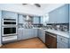 Charming kitchen featuring blue cabinets, stainless steel appliances, and modern backsplash at 2258 World Parkway W Blvd # 8, Clearwater, FL 33763
