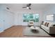 Bright living room with a large window providing great natural light and access to the complex at 2258 World Parkway W Blvd # 8, Clearwater, FL 33763