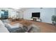 Bright living room features hardwood floors, stylish furniture, and adjacent dining area at 2258 World Parkway W Blvd # 8, Clearwater, FL 33763
