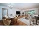Well lit living room with dining table and chairs, hardwood floors, and an open floor plan at 2258 World Parkway W Blvd # 8, Clearwater, FL 33763