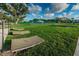 Grassy community lounge area with green landscaping and lawn furniture offers a place for relaxation and socializing at 2258 World Parkway W Blvd # 8, Clearwater, FL 33763