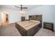 Main bedroom with carpet, ceiling fan, a large bed frame with drawer storage, and furnishings at 2258 World Parkway W Blvd # 8, Clearwater, FL 33763