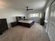 Main bedroom features a ceiling fan, carpet, and a large bed frame with storage underneath at 2258 World Parkway W Blvd # 8, Clearwater, FL 33763