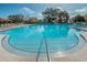 A large community pool with ample lounge chairs available for residents and guests at 2258 World Parkway W Blvd # 8, Clearwater, FL 33763
