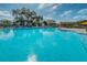 A large community pool with ample lounge chairs available for residents and guests at 2258 World Parkway W Blvd # 8, Clearwater, FL 33763