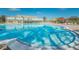 A large community pool with ample lounge chairs and umbrellas available for residents and guests at 2258 World Parkway W Blvd # 8, Clearwater, FL 33763