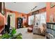 Living room with terracotta walls, comfy seating, and a home library at 2297 Anchor Ave, Spring Hill, FL 34608