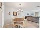 Bright dining area with round table and four chairs, adjacent to living room at 2433 Beacon Dr, Port Charlotte, FL 33952