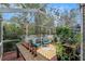 Lush, screened-in patio with seating and sunburst rug at 2837 Bayshore Trails Dr, Tampa, FL 33611