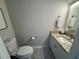 Updated bathroom with granite vanity and tile floor at 3053 Overlook Pl, Clearwater, FL 33760
