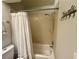 Simple bathroom with shower, tub, and white curtain at 3053 Overlook Pl, Clearwater, FL 33760