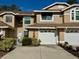 Two-story townhome with attached garage and landscaping at 3053 Overlook Pl, Clearwater, FL 33760