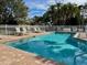 Community pool with lounge chairs and brick pavers at 3053 Overlook Pl, Clearwater, FL 33760
