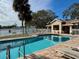 Community pool with patio furniture and lake view at 3053 Overlook Pl, Clearwater, FL 33760
