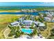 Community clubhouse and pool area with tropical landscaping at 380 Aruba Cir # 203, Bradenton, FL 34209