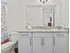 Bathroom with granite countertop, white cabinets, and shower at 380 Aruba Cir # 203, Bradenton, FL 34209