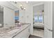 Double vanity bathroom with granite countertop and bedroom view at 380 Aruba Cir # 203, Bradenton, FL 34209