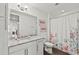 Bathroom with granite countertop, white cabinets, and shower at 380 Aruba Cir # 203, Bradenton, FL 34209