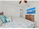 Main bedroom with a king-size bed and large TV at 380 Aruba Cir # 203, Bradenton, FL 34209