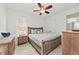 Guest bedroom with a queen-size bed, dresser, and ceiling fan at 380 Aruba Cir # 203, Bradenton, FL 34209