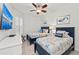 Bedroom with two twin beds, dresser and ceiling fan at 380 Aruba Cir # 203, Bradenton, FL 34209
