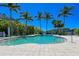 Relaxing community pool with palm trees at 380 Aruba Cir # 203, Bradenton, FL 34209