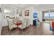 Elegant dining room features a glass table and coastal decor at 380 Aruba Cir # 203, Bradenton, FL 34209