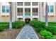 Welcoming entryway to Hemisphere Dancer with lush landscaping at 380 Aruba Cir # 203, Bradenton, FL 34209