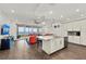 Modern kitchen with granite island, stainless steel appliances, and waterfront views at 380 Aruba Cir # 203, Bradenton, FL 34209