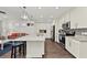 White kitchen features granite countertops and island seating at 380 Aruba Cir # 203, Bradenton, FL 34209