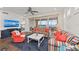 Spacious living area features water views and colorful sofas at 380 Aruba Cir # 203, Bradenton, FL 34209