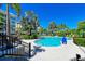 Community pool with surrounding lounge chairs at 380 Aruba Cir # 203, Bradenton, FL 34209
