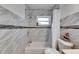 Updated bathroom with marble tile, shower, and bathtub at 4250 37Th S St # 5, St Petersburg, FL 33711