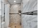 Walk-in shower with marble tile and built-in shelving at 4250 37Th S St # 5, St Petersburg, FL 33711