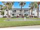 White condo building with balconies, landscaping, and palm trees at 4250 37Th S St # 5, St Petersburg, FL 33711