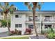 White condo building with balconies and palm trees at 4250 37Th S St # 5, St Petersburg, FL 33711