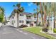 White condo building with balconies and palm trees at 4250 37Th S St # 5, St Petersburg, FL 33711
